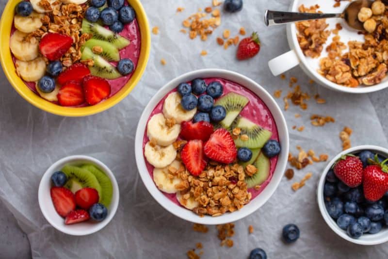 acai bowls topped with fruit and oats