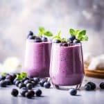 two blueberry smoothies - ai generated image