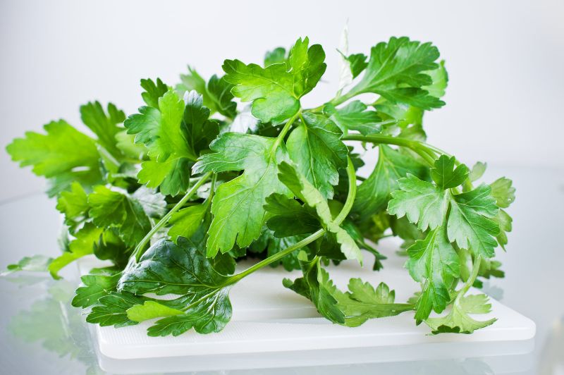 parsley on a white cutting board